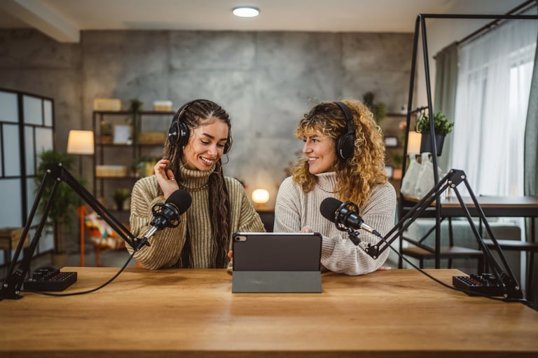 Two young adult women stream audio podcast use microphone