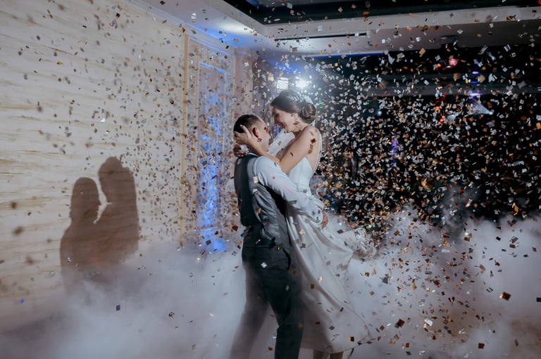 Couple dancing with confetti at their wedding celebration